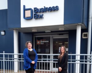 Ruth at front of Leicester office with Office Manager